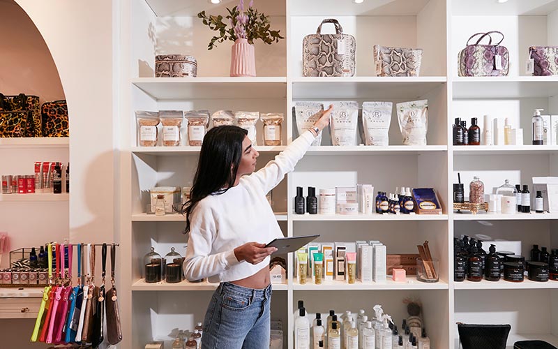 retail associate stocking shelves inside a store