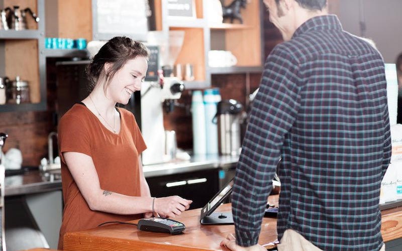 coffee shop employee helping a customer