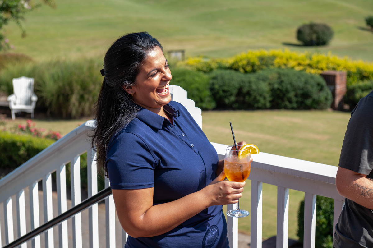 A women having a great time at a corporate golf event