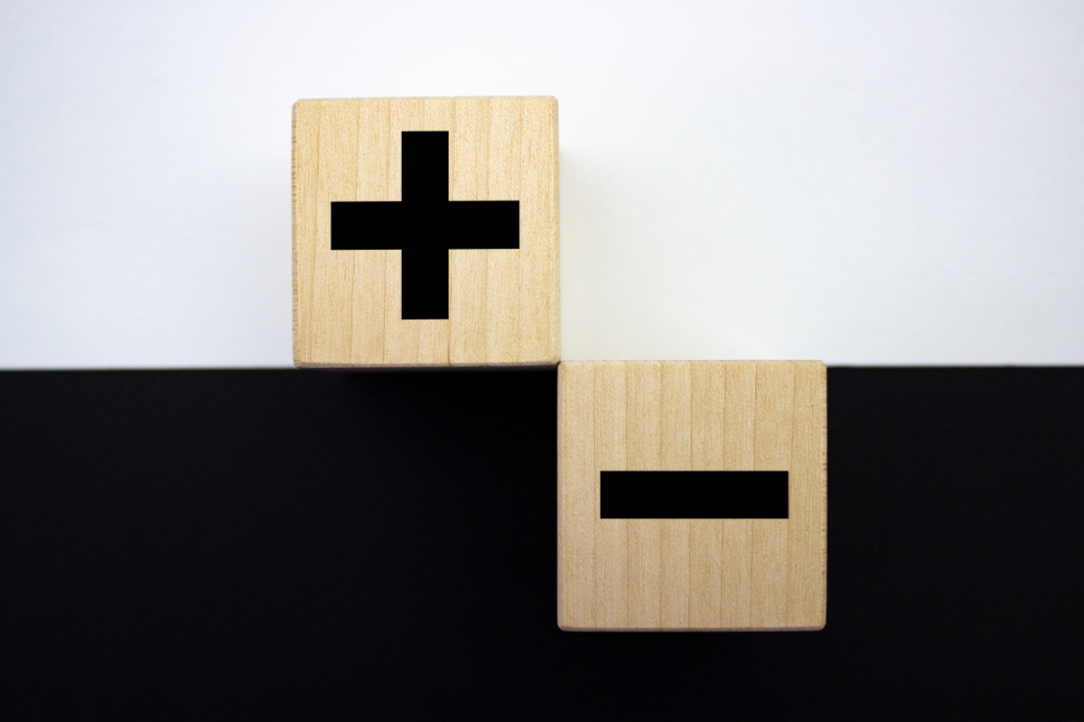 plus and minus symbols on wooden blocks