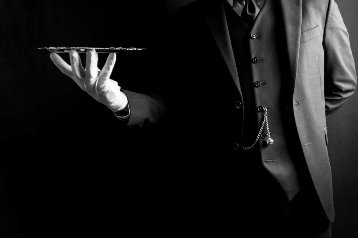 waiter with gloves carrying empty platter