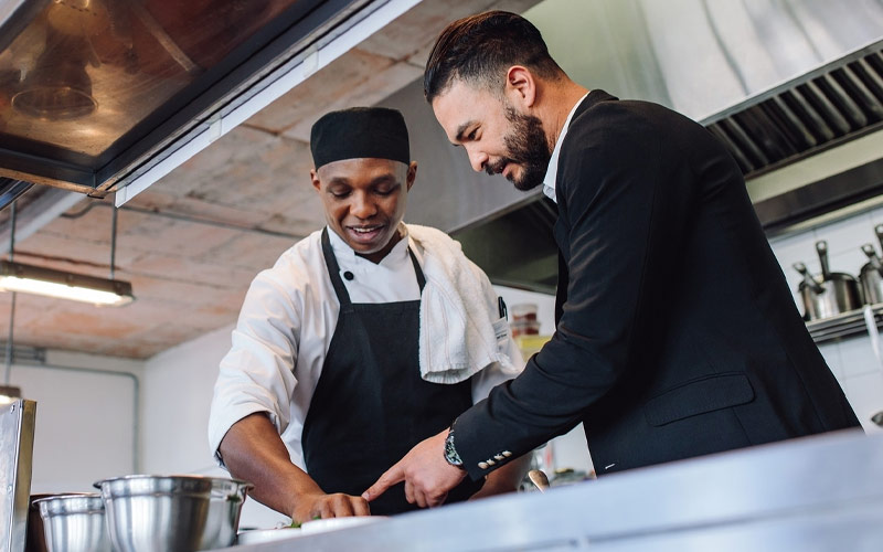 Businessman and chef working